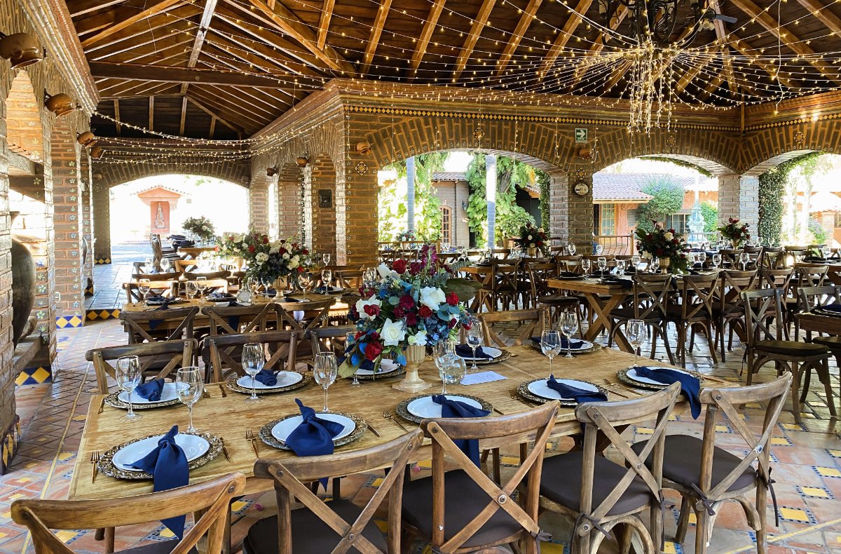 Mesas decoradas en tonos azules y tintos para boda en terraza 